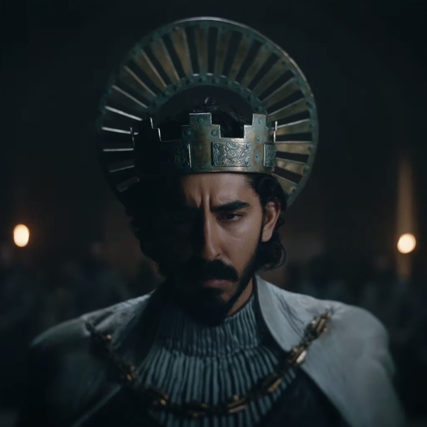Gawain wears a tarnished crown and looks sternly forward.